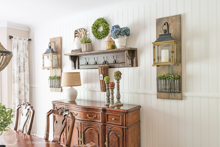 DIY-farmhouse-style-planked-shiplap-wall-with-a-vintage-mantel-shelf-buffet-and-Fixer-Upper-style-wall-lanterns-1