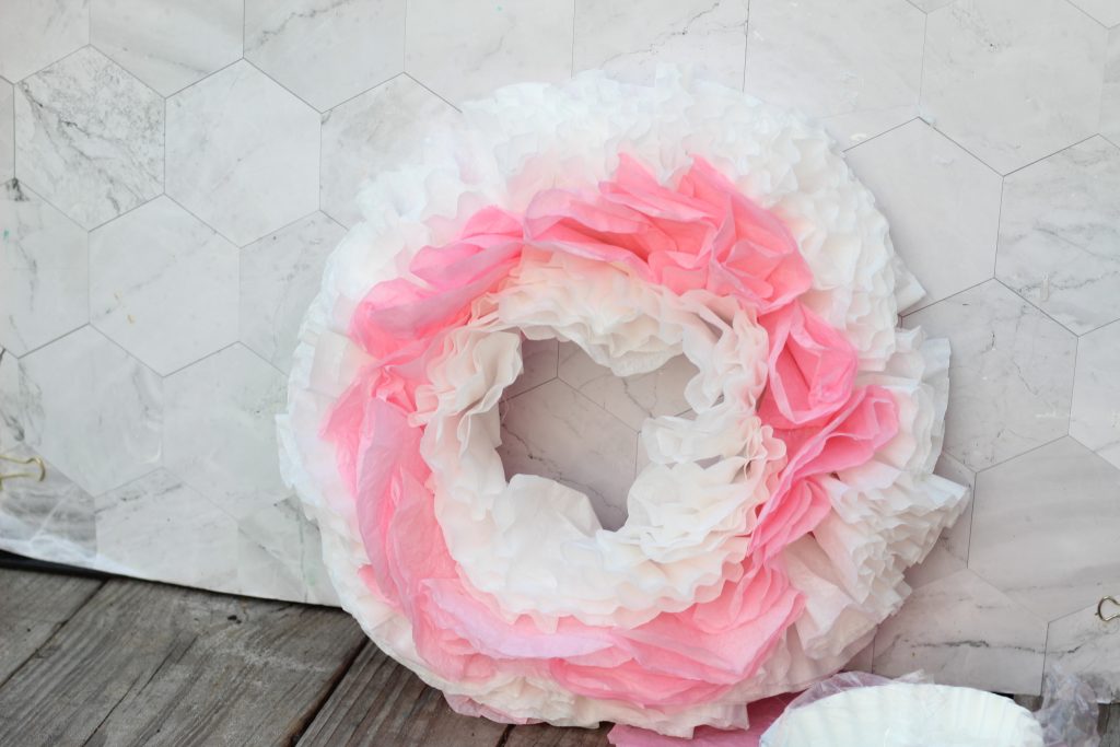 This simple and easy to DIY Dip Dye Coffee Filter Wreath is an inexpensive and charming way to add a little pop of pink to your home or office decor. It would even look fabulous on the front door!