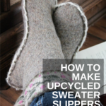 crossed feet wearing homemade sweater slippers with "how to make upcycled sweater slippers" text over lay